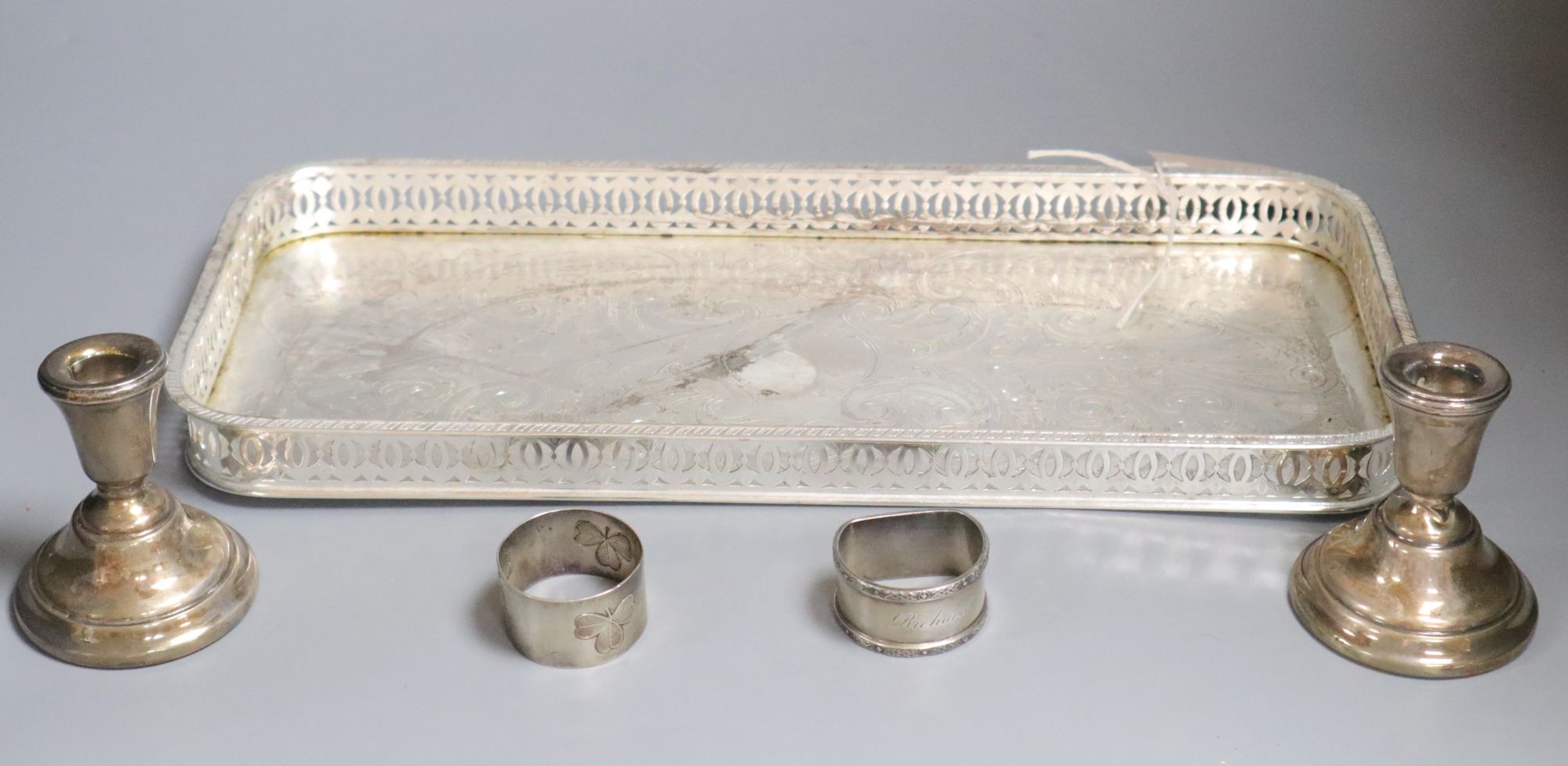 A plated tray, a pair of silver dwarf candlesticks and two napkin rings